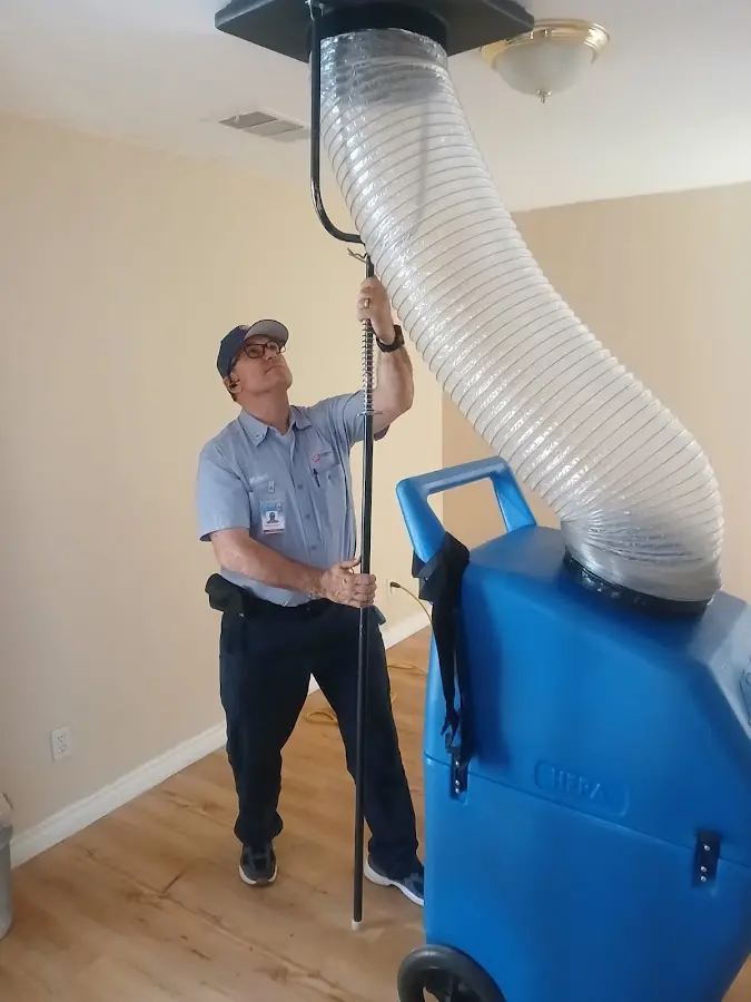 Furnace Tune-Up technician using HEPA equipment in Houlton